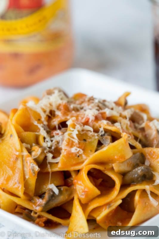 Earthy Mushroom Pappardelle 4 pasta with a mushroom tomato sauce topped with parmesan cheese