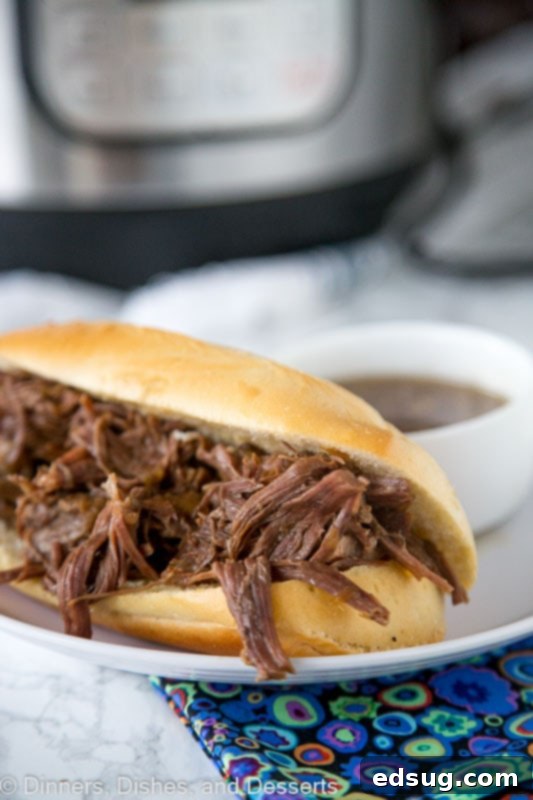 Melt-in-Your-Mouth Instant Pot French Dip Sandwiches 2 A plate with a sandwich of French dip and Slow cooker