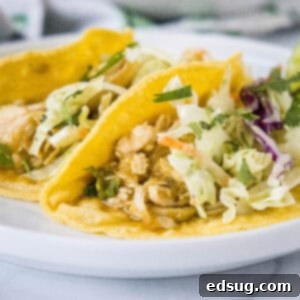 Green Goddess Chicken 2 Two salsa verde chicken tacos on a white plate, ready for serving.