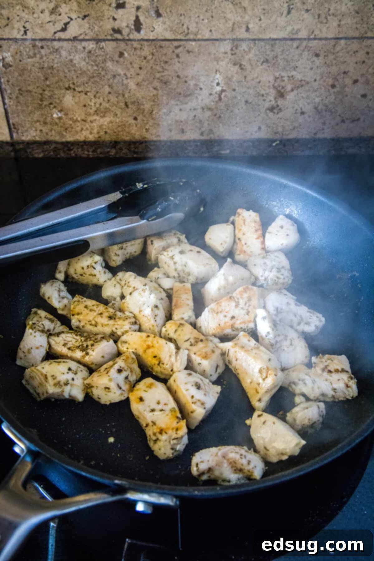 chicken browning in a skillet with olive oil