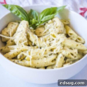 cropped close up of chicken pesto pasta in a white bowl