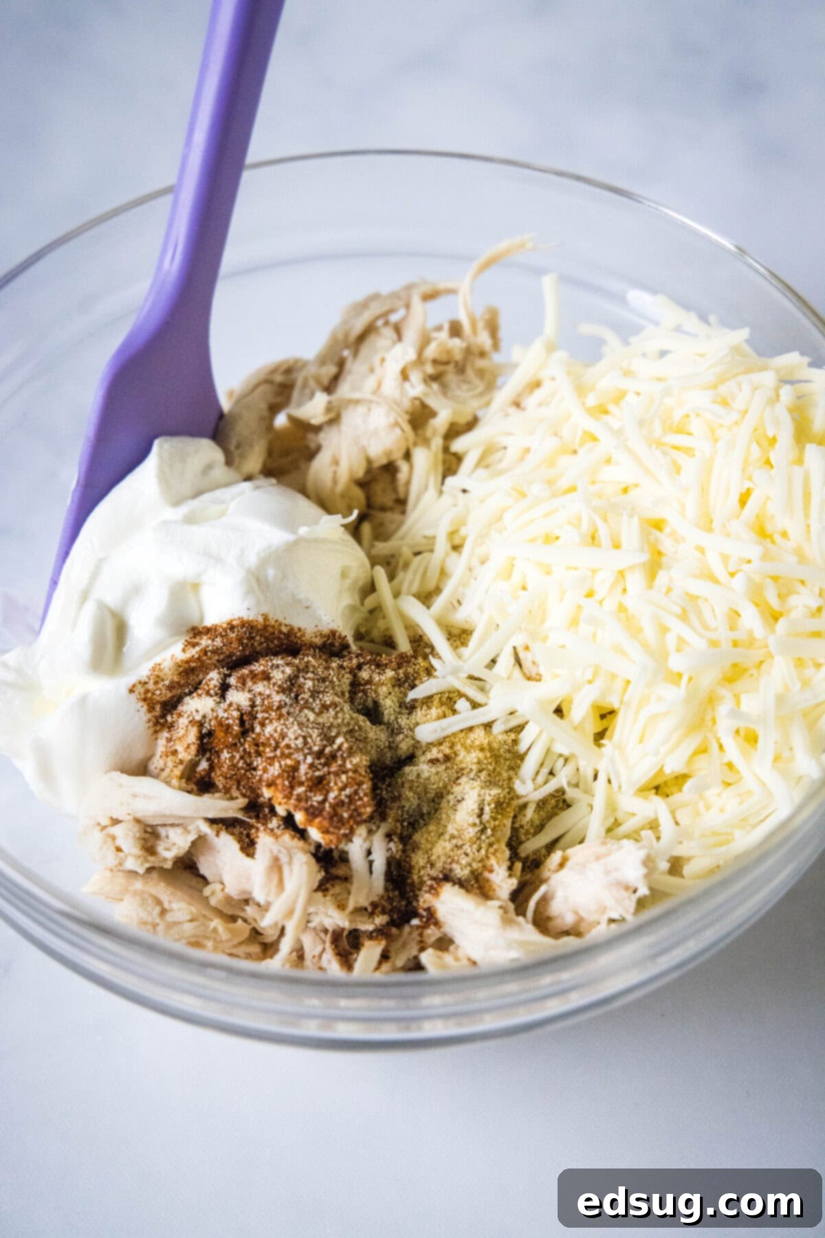 Zesty Green Chile Chicken Enchiladas 5 mixing together green chile chicken enchilada filling ingredients in a bowl