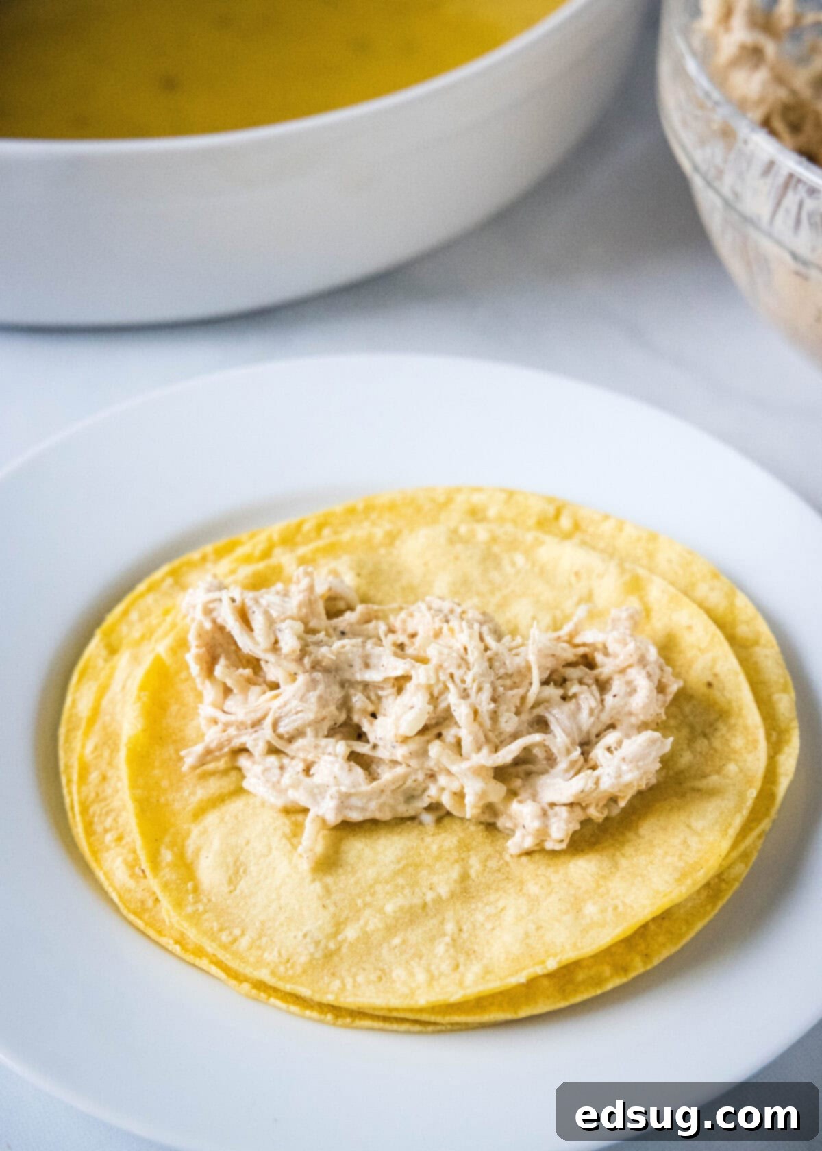 Zesty Green Chile Chicken Enchiladas 6 added chicken filling to the center of a corn tortilla