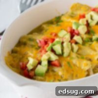 Zesty Green Chile Chicken Enchiladas 10 a dish of enchiladas topped with tomatoes and avocados