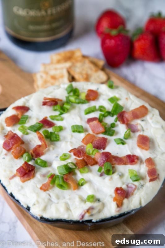 A warm, gooey cheese dip recipe, specifically a blue cheese dip, perfectly paired with wine for an elegant appetizer