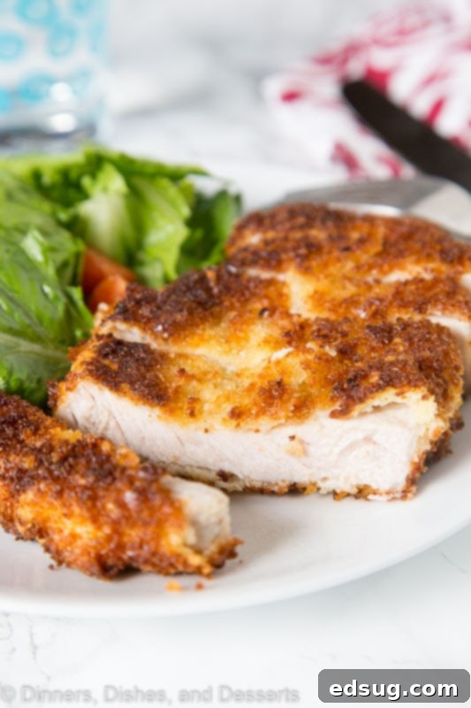 Crunchy Pork Cutlet Perfection 2 Crispy Pork Cutlet - tender boneless pork chops breaded and pan fried to crispy perfection. Served with a salad for a delicious meal any night of the week.