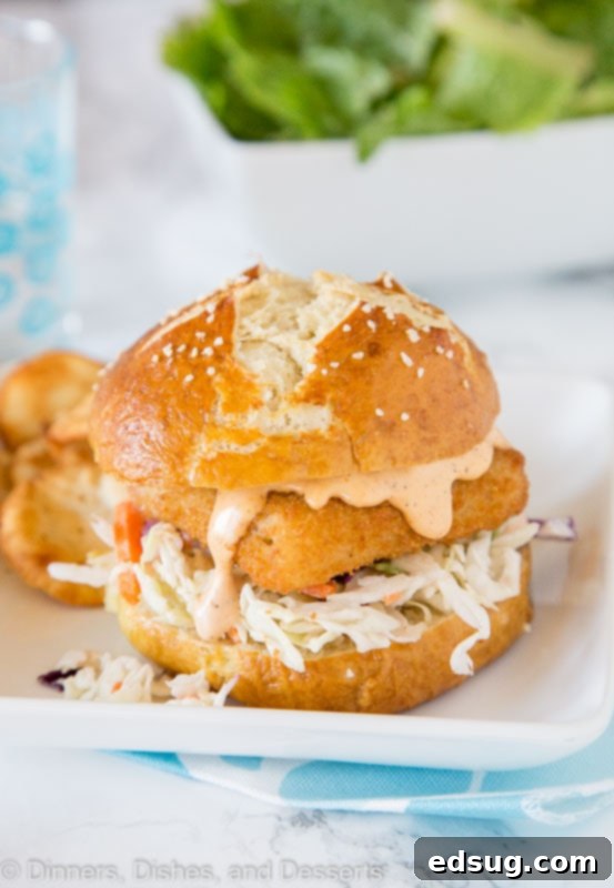 Spicy Fish Sandwich Sensation 4 Spicy Fish Sandwich - Crispy fish sandwich with creamy coleslaw and a spicy tartar sauce. Easy dinner recipe for night of the week.