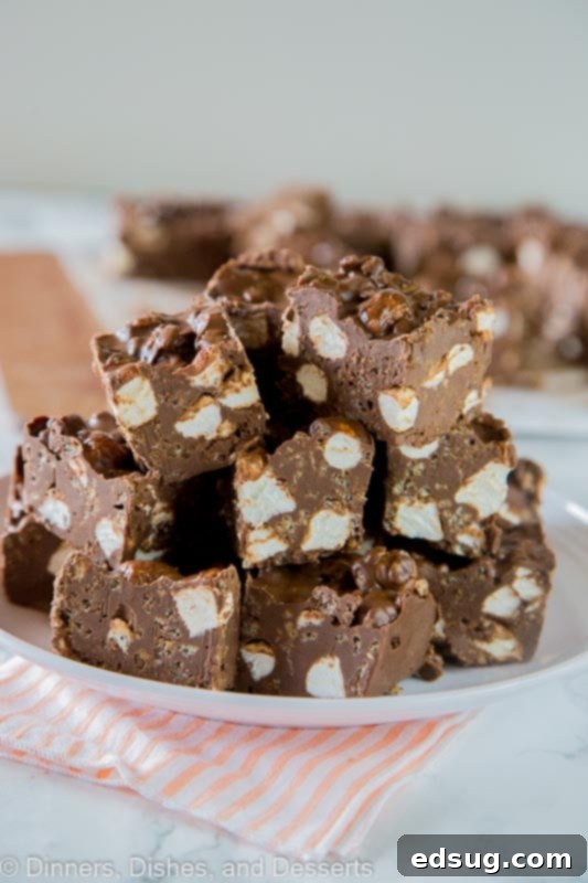 Decadent Chocolate Avalanche Bars 3 Chocolate Avalanche Bars - super easy no bake avalanche cookies turned into even easier bars made with 3 kinds of chocolate! A tray of freshly made chocolate avalanche bars, waiting to be sliced.