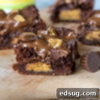 Peanut Butter Stuffed Brownies - rich, fudge brownies that are stuffed with peanut butter cups, topped with melted chocolate and more peanut butter cups!