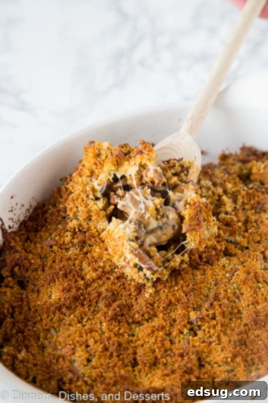 Savory Sausage Stuffed Mushroom Casserole 2 mushroom casserole in a dish with a spoon