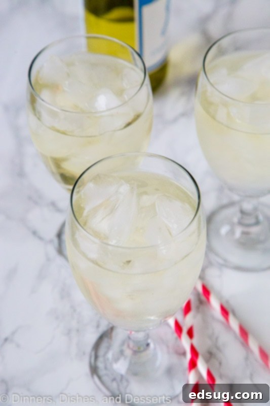 The Perfect White Wine Spritzer 3 A close up of a wine glass, with Spritzer and Dinner