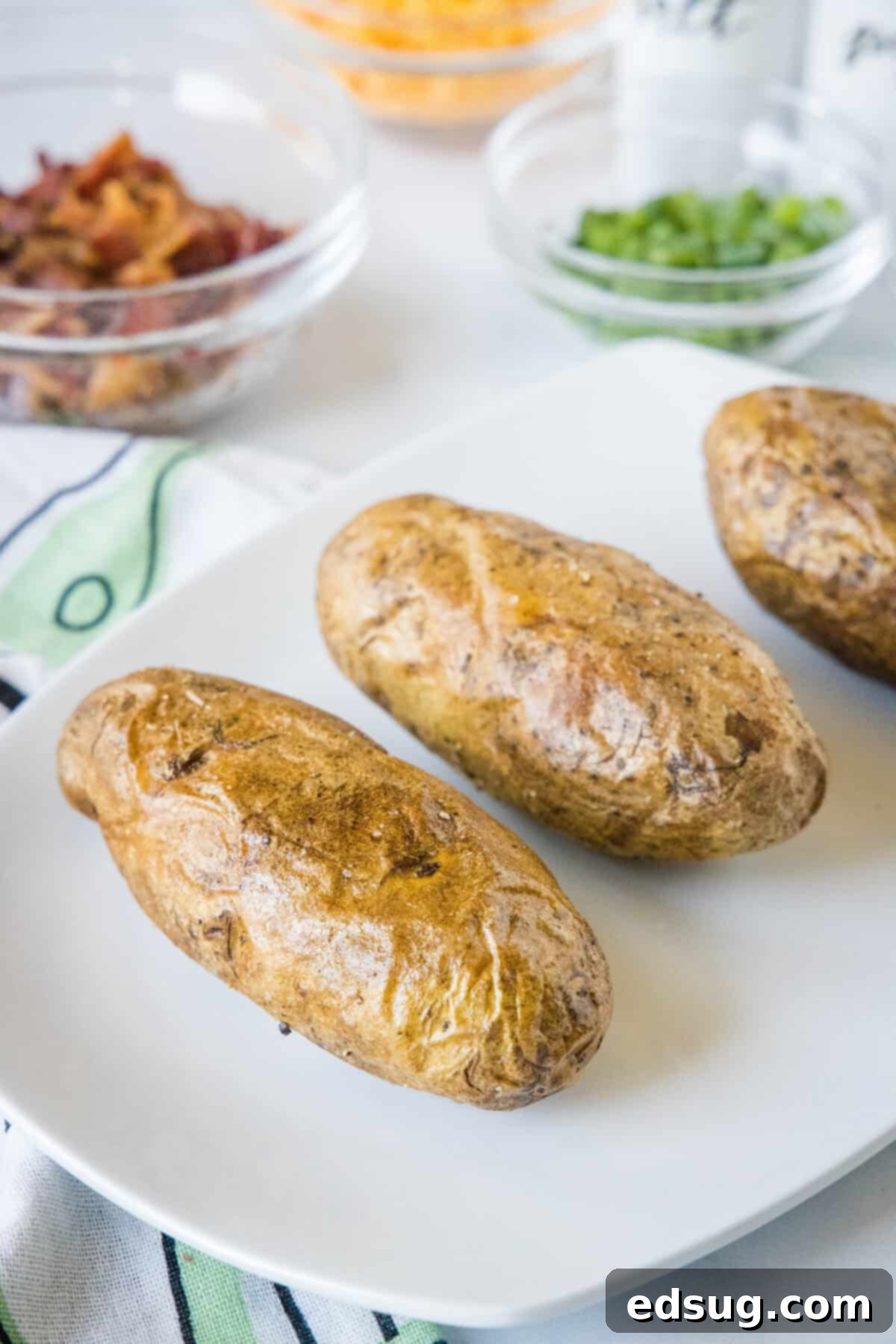Ultimate Loaded Baked Potatoes 4 baked potatoes on a serving platter
