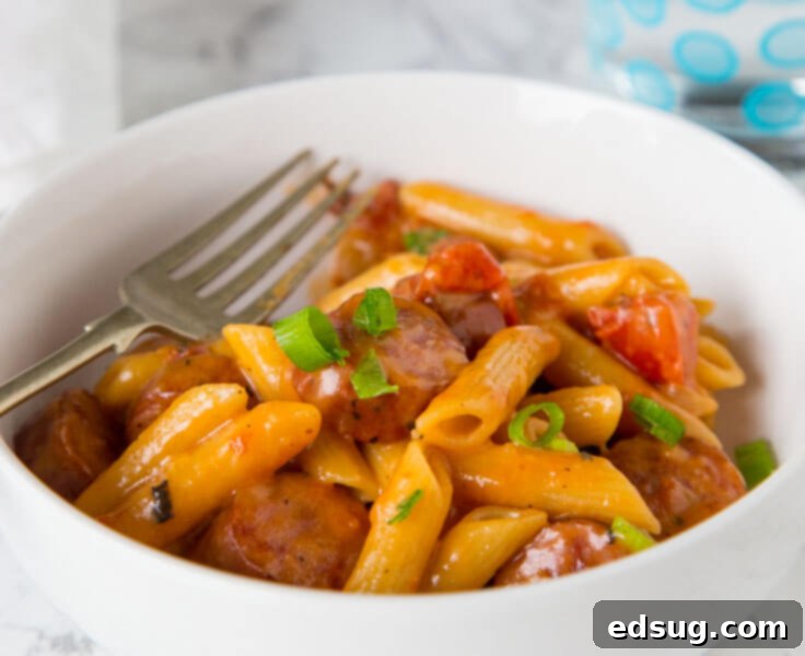 A bubbling One Pan Cheesy Sausage Pasta, an easy and quick dinner recipe.