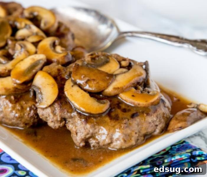 Classic Hamburger Steaks with Mushroom Gravy, a comforting and budget-friendly weeknight dinner.