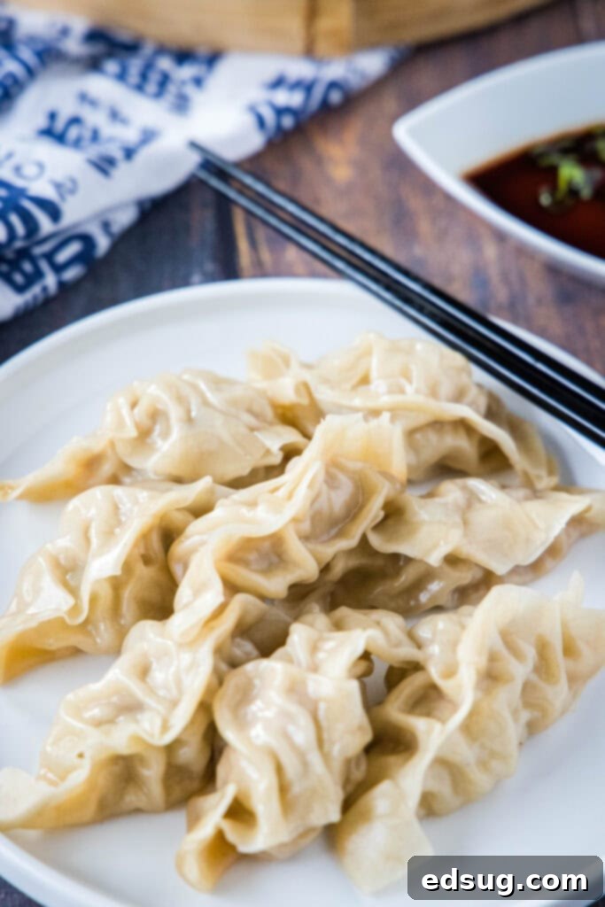 A beautifully arranged plate of freshly steamed pork dumplings, garnished with chopped green onions, ready to be enjoyed.