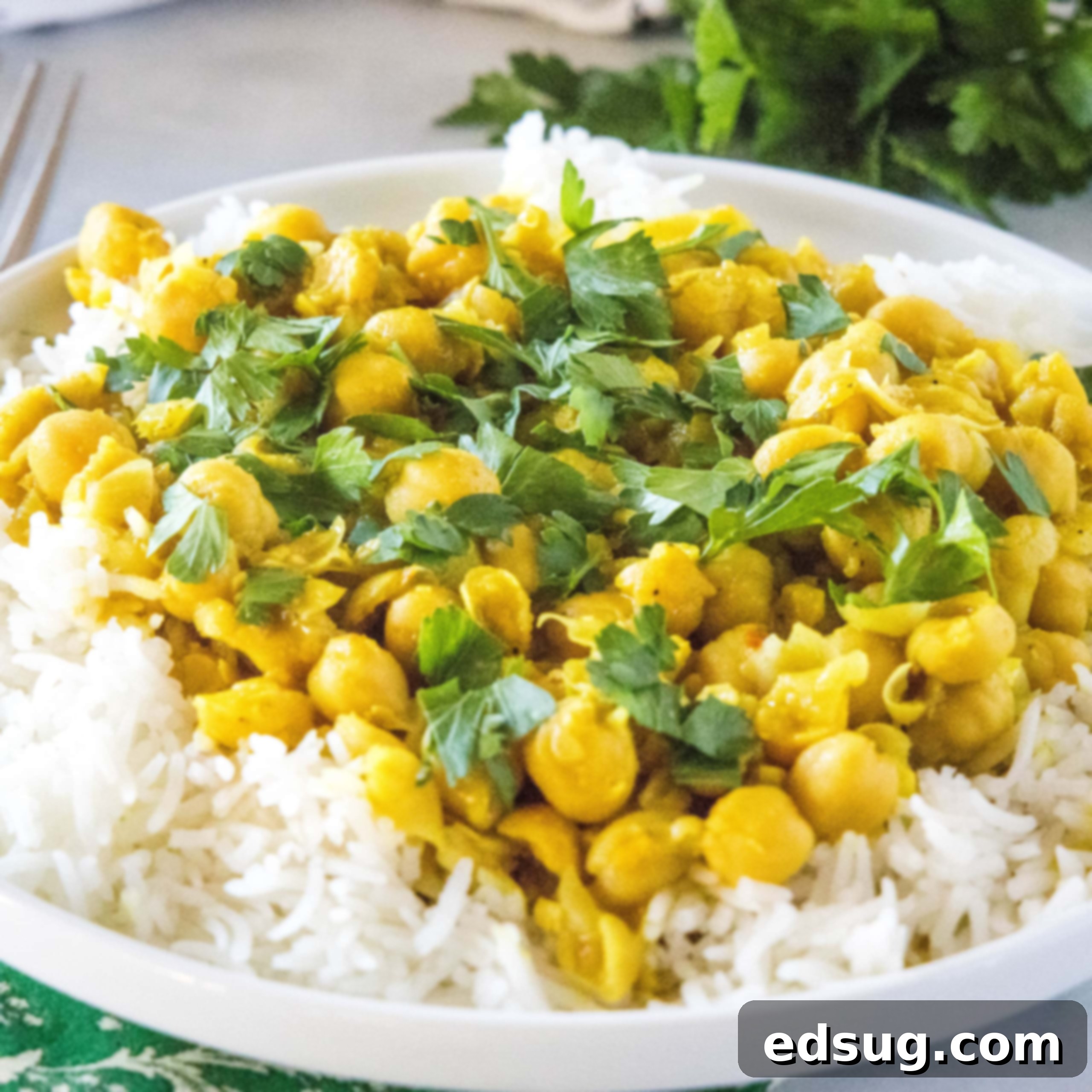 close up chickpea curry on a white plate