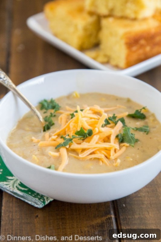 Close-up of creamy Southwestern Chicken Corn Chowder, highlighting the chicken, corn, and vibrant spices. Ideal for a quick dinner.