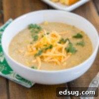 A bowl of Southwestern Chicken Corn Chowder on a rustic wooden table.