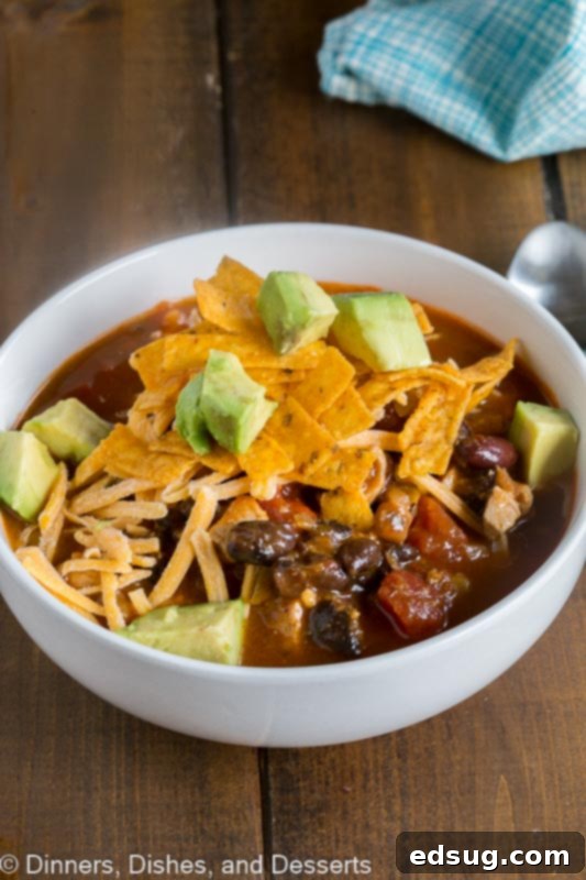 Zesty Chicken Enchilada Bowl 2 A bowl of homemade Chicken Enchilada Soup, garnished with fresh cilantro and a dollop of sour cream, ready to warm you up.