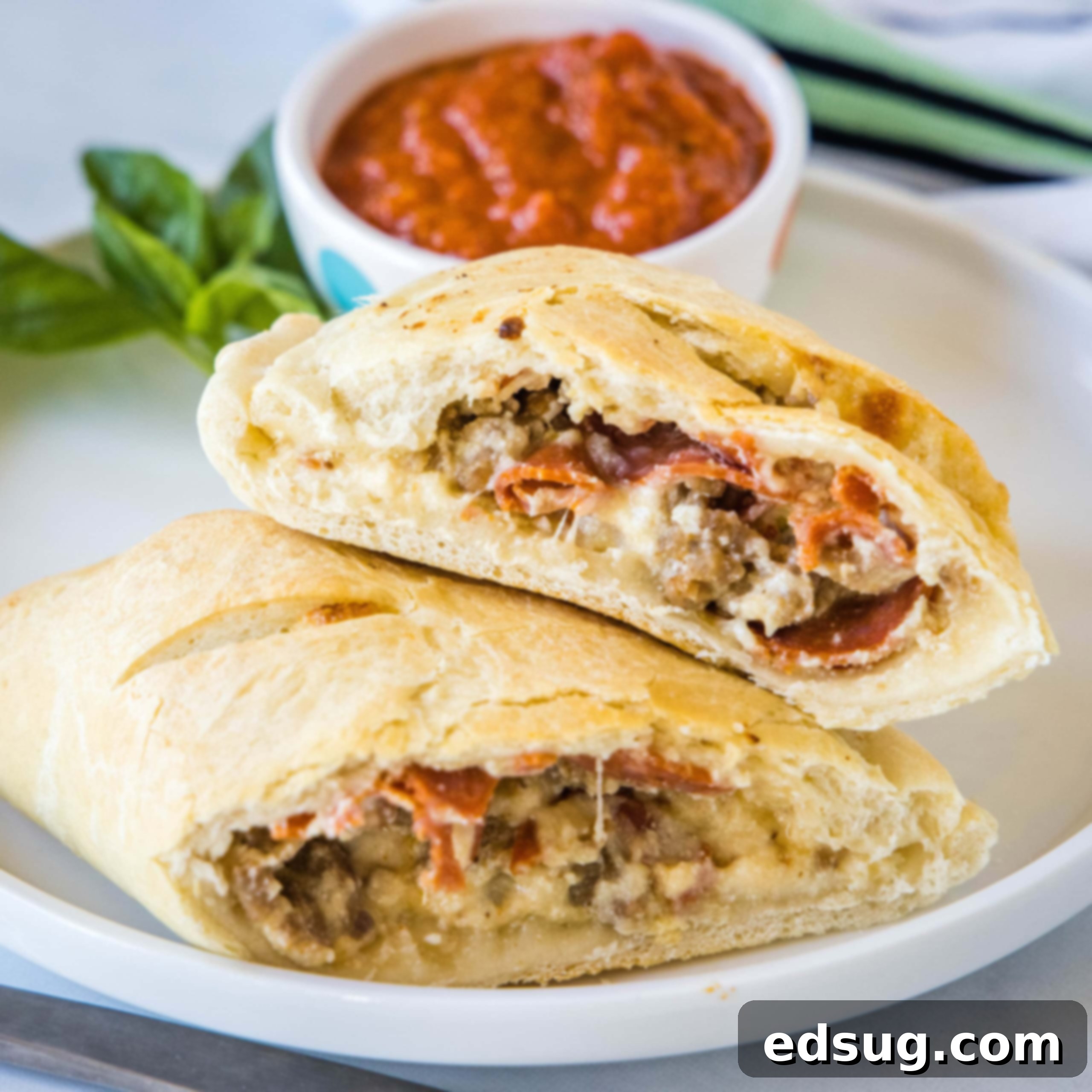 close up calzones cut in half on a plate