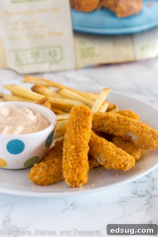 Cajun Kick Dipping Sauce 3 Golden fish sticks ready for a generous dip in spicy Cajun sauce