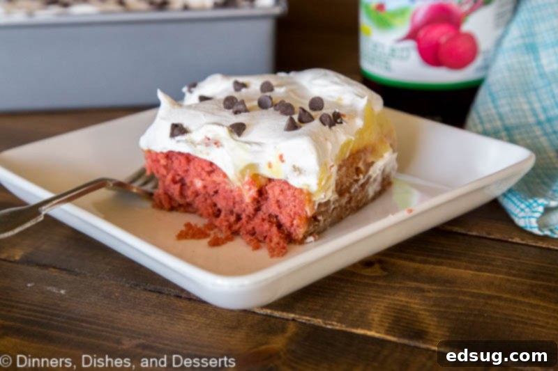 Luscious Red Velvet Poke Cake 4 A single, delectable serving of Beet Red Velvet Poke Cake, perfectly presented on a white plate with a fork, inviting you to take a bite.