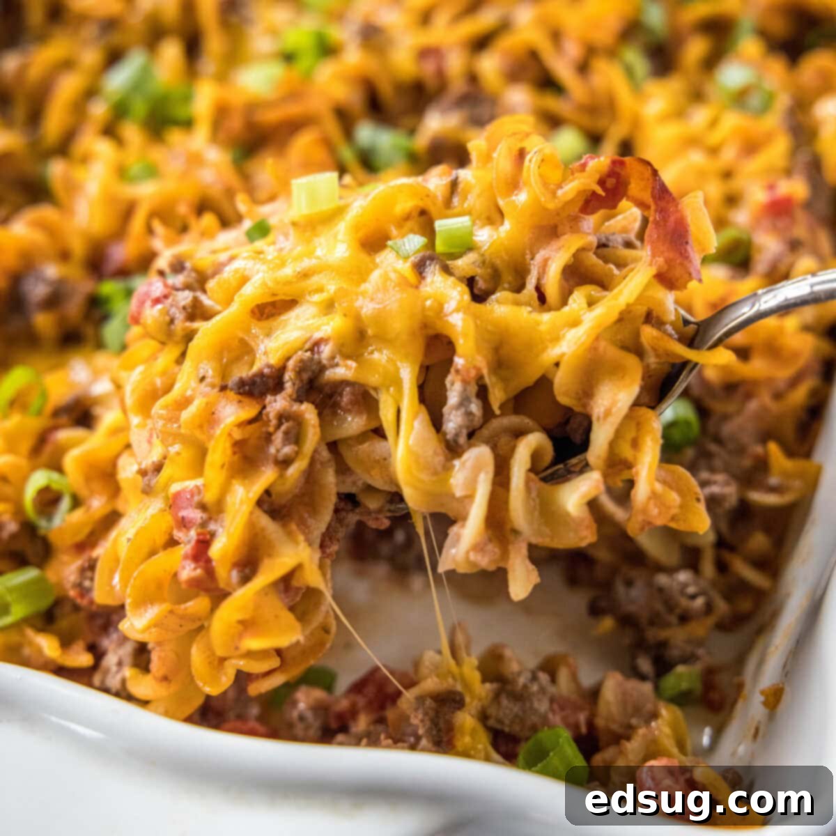 Close up of a slice of beef noodle casserole being removed from a dish
