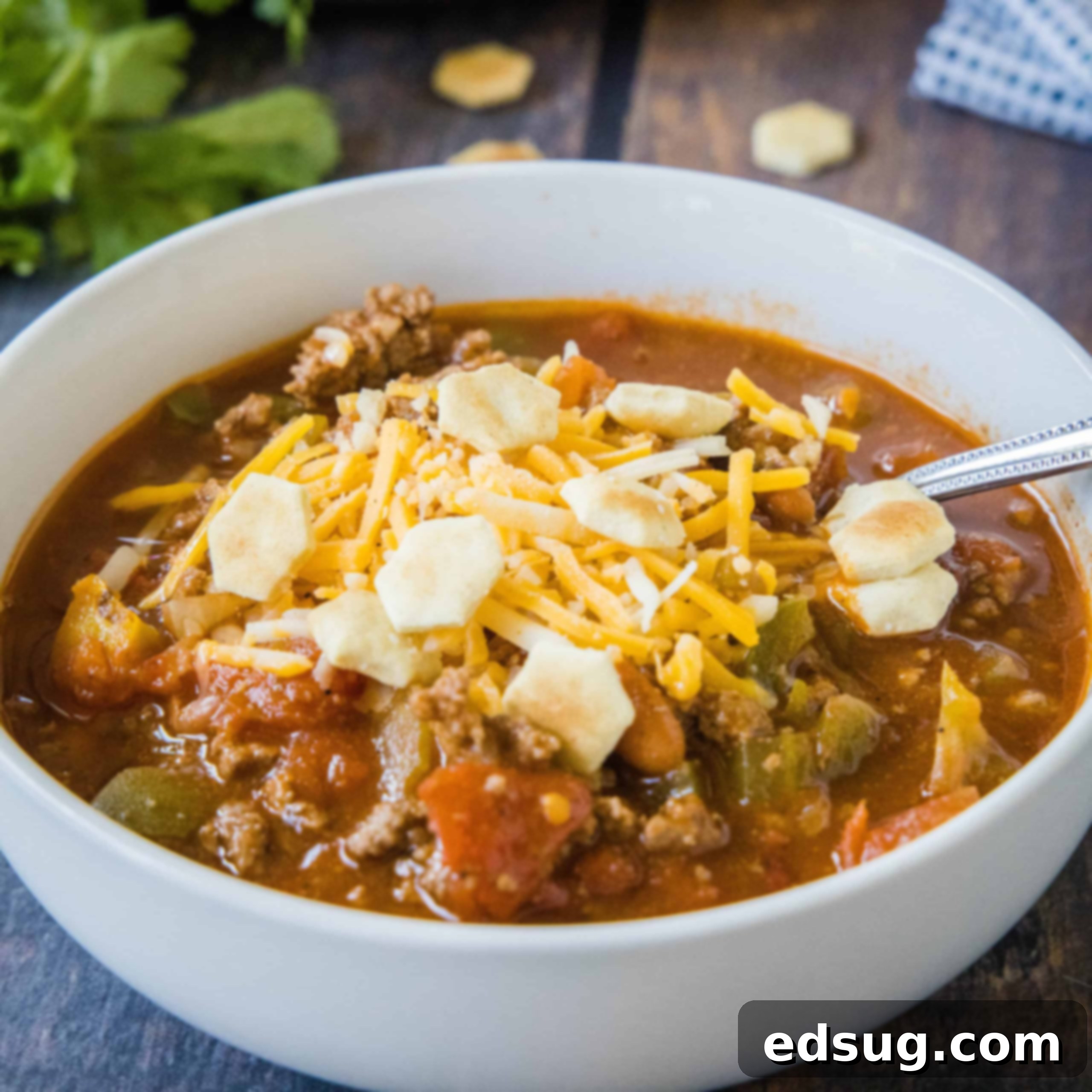 cropped close up bow of chili with cheese and crackers