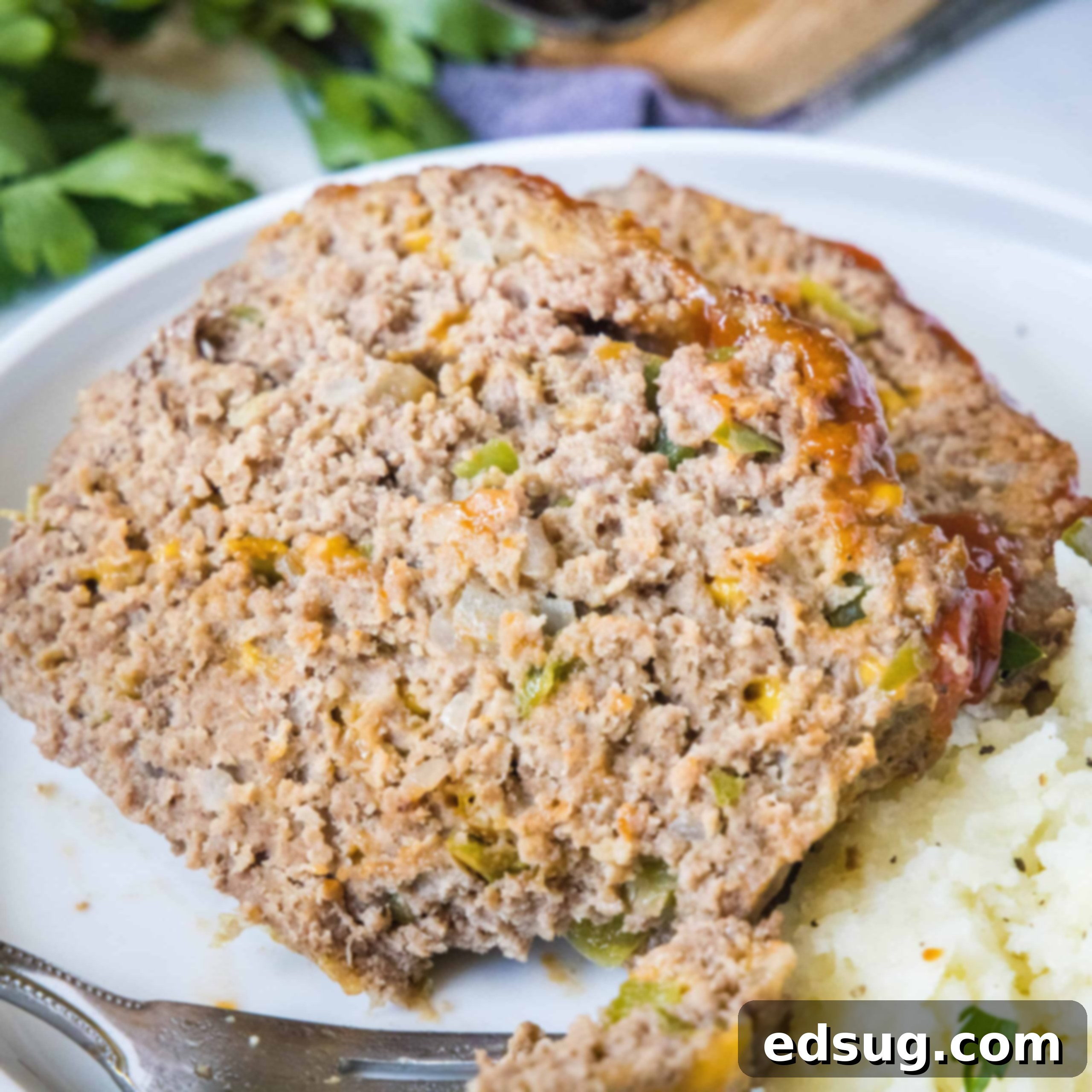 cropped close up slice of meatloaf on a plate