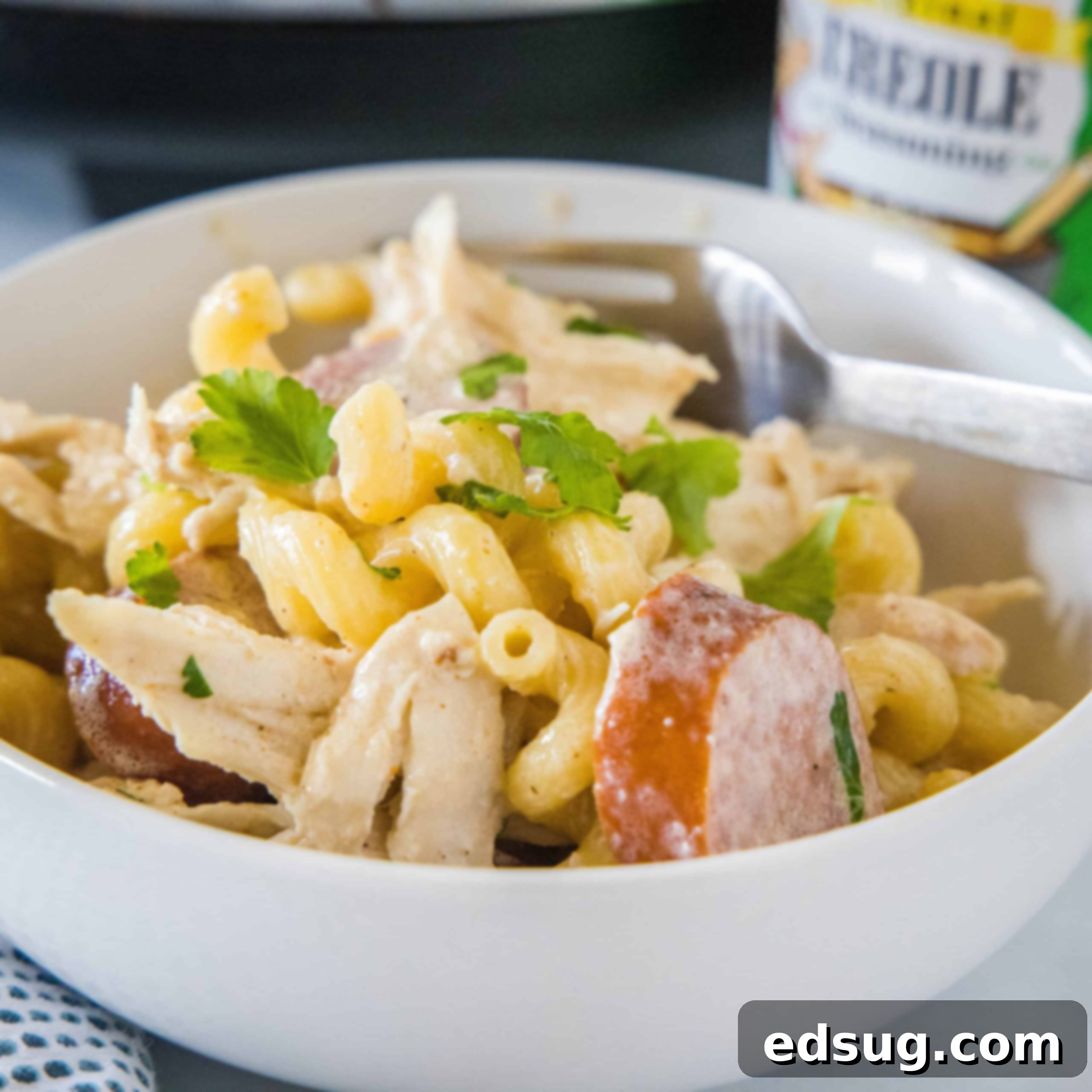 Crockpot Cajun chicken pasta in a bowl with a fork.