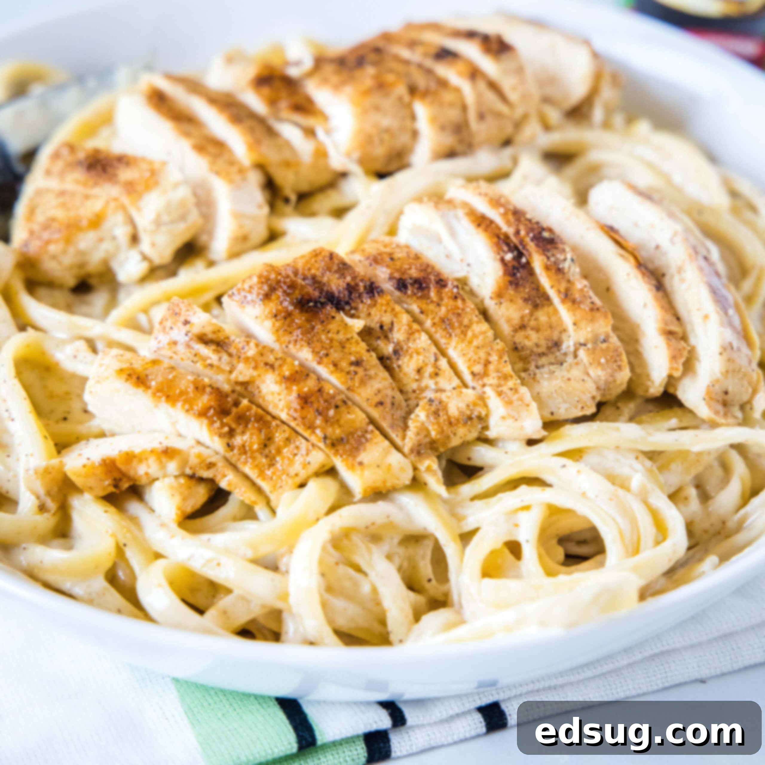 cajun chicken alfredo close up with sliced chicken on top