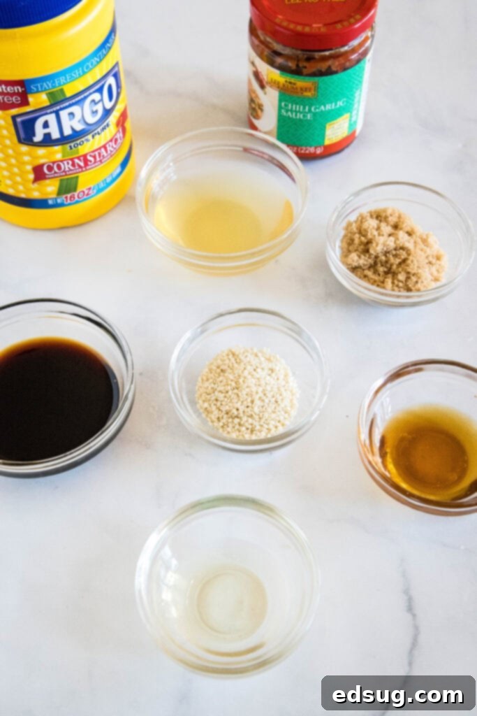 Various ingredients for kung pao sauce including soy sauce, brown sugar, sesame oil, and chili garlic paste