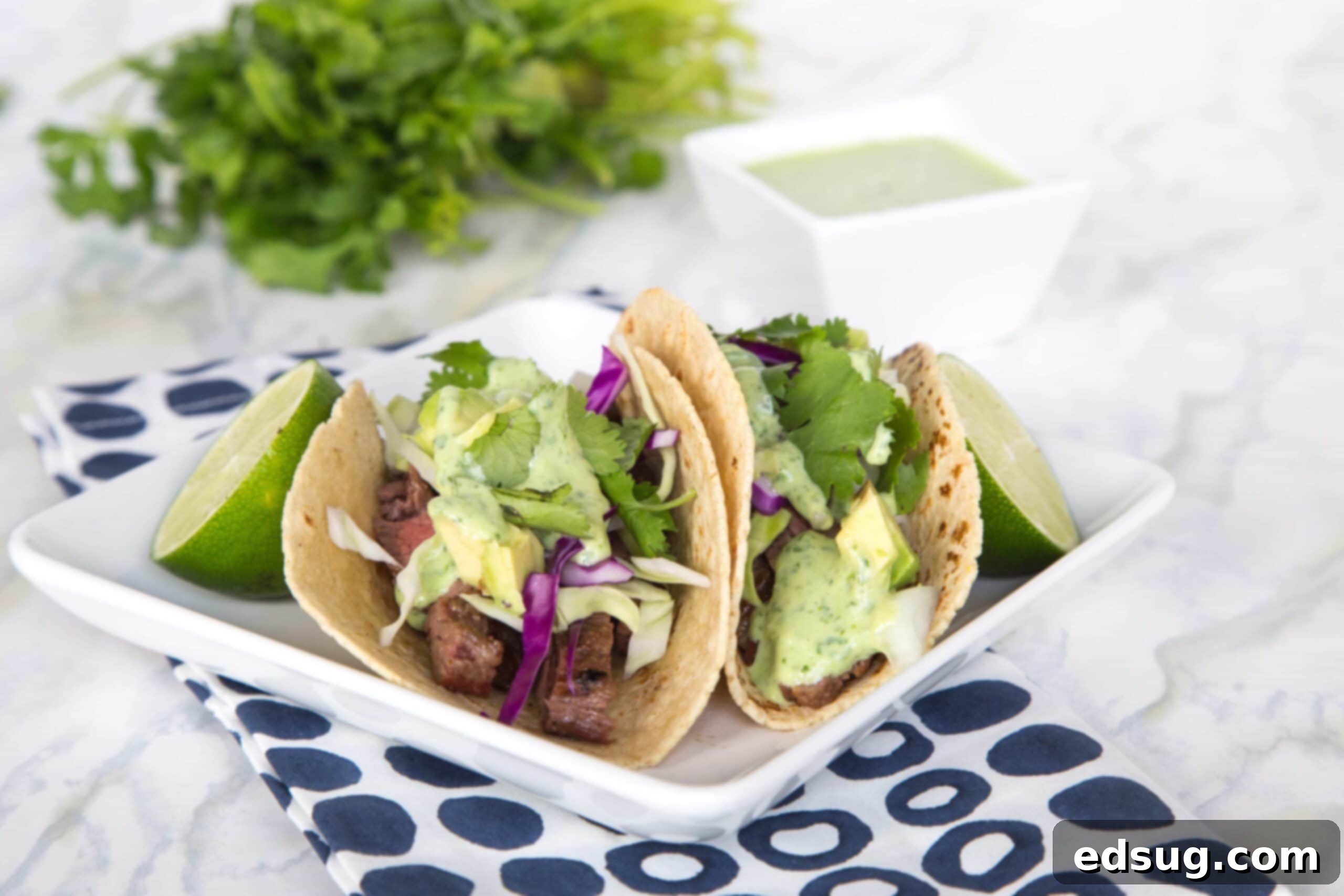 Steak Street Tacos – tender grilled skirt steak wrapped in a charred corn tortilla and topped with a creamy cilantro lime sauce. Just like Southern California at home in no time!