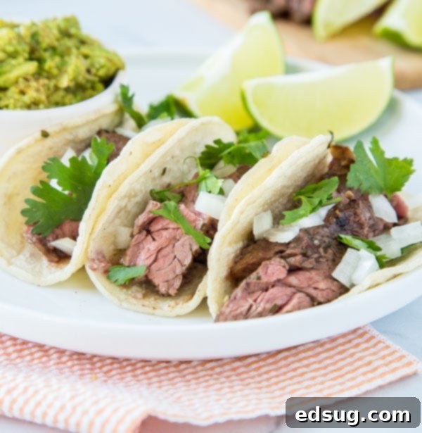 Flank Steak Tacos - Juicy flank steak marinated in lime juice, garlic, cilantro and more. Served in tortillas with your favorite toppings for taco night! 
