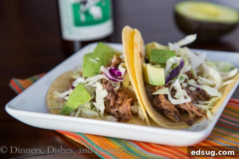 Close up of delicious slow cooker chipotle beef tacos on a plate, ready to be enjoyed.