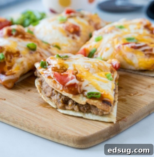 A delicious slice of Mexican pizza resting on a wooden cutting board, ready to be served.