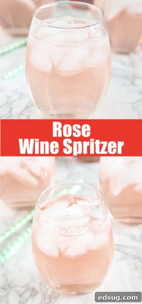 A close-up shot of a rosé wine spritzer in a glass with ice and a lemon slice.