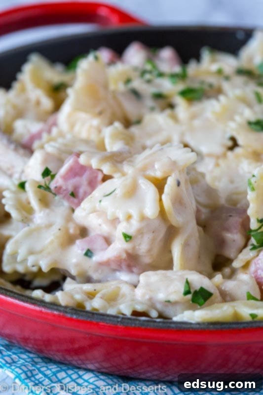 Creamy chicken pasta cordon bleu in a skillet