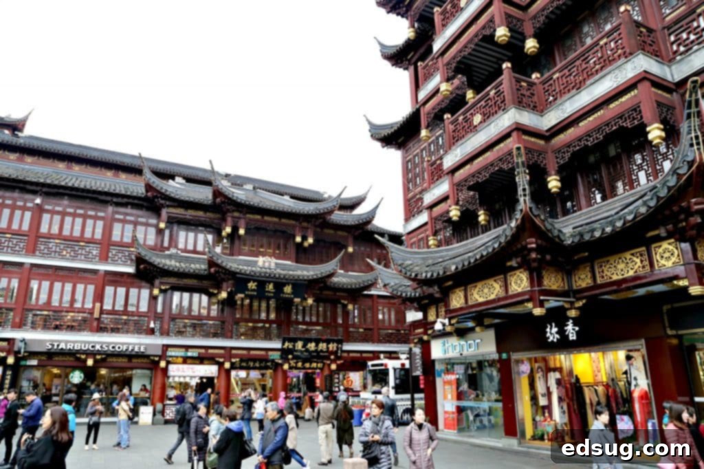 10 Unmissable Shanghai Experiences 11 A vibrant bazaar scene near Yu Garden in Shanghai, with traditional Chinese architecture and numerous shops under a bright sky.