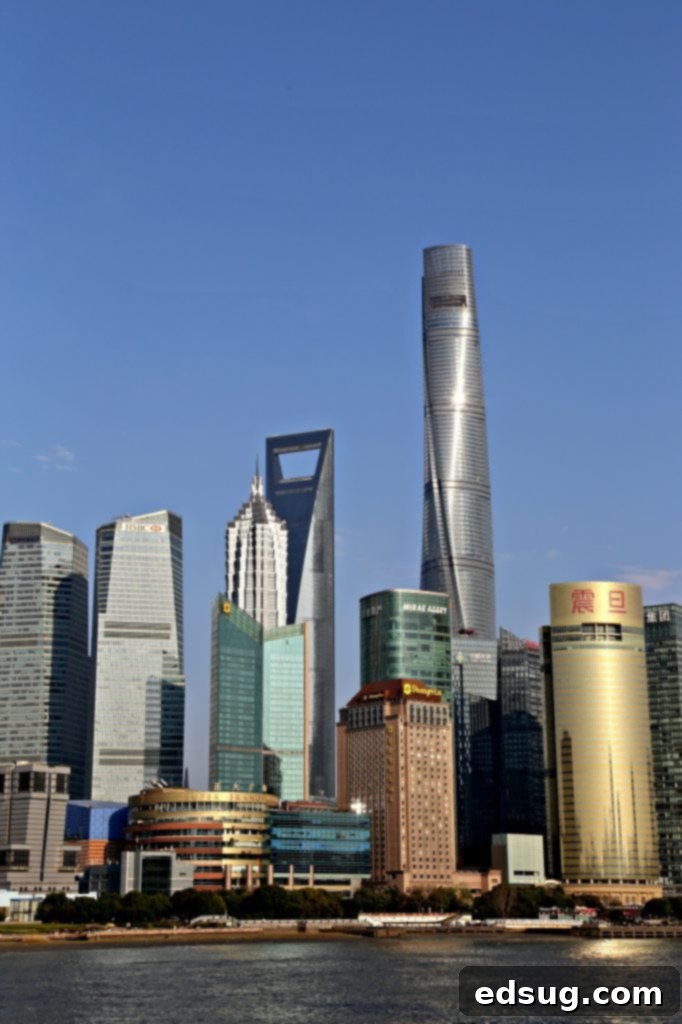 10 Unmissable Shanghai Experiences 10 A wide body of water with a bustling city skyline in the background, possibly depicting a river near a market area in Shanghai.