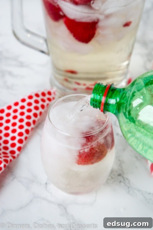 Strawberry Wine Spritzer Recipe - Add your strawberries to your favorite white wine and make this crisp, cool, and refreshing wine spritzer. Great for sipping any time of year. Strawberry white Wine spritzer recipe