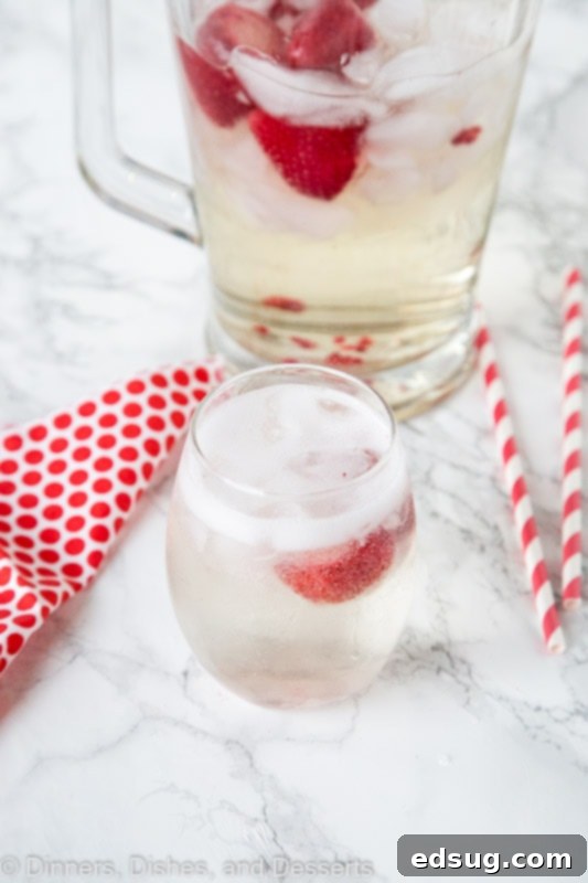 Strawberry Wine Spritzer Recipe - Add your strawberries to your favorite white wine and make this crisp, cool, and refreshing wine spritzer. Great for sipping any time of year. Strawberry wine spritzer