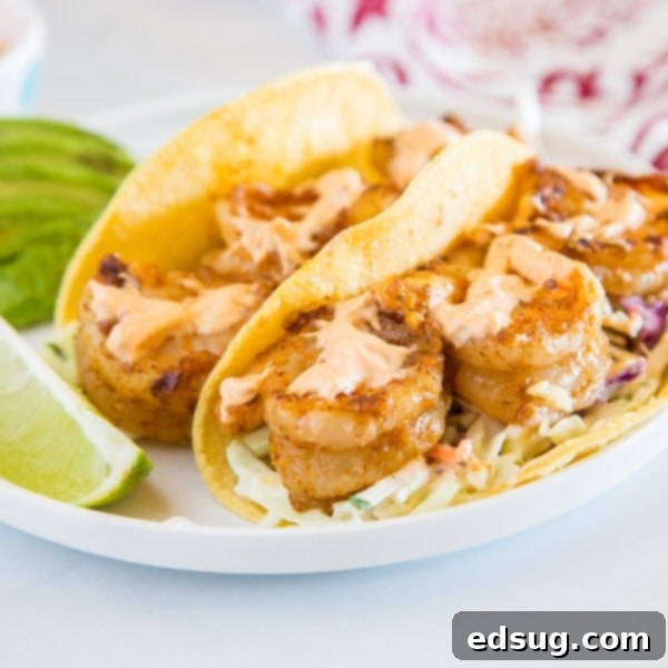 Chipotle Shrimp Tacos on a plate, featuring cool lime coleslaw and creamy chipotle sauce.