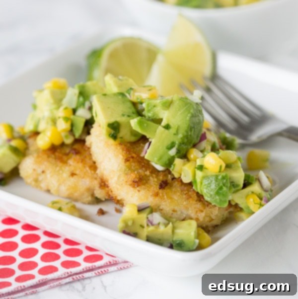 Delicious Shrimp Cakes topped with fresh Corn and Avocado Salsa, offering a buttery and spicy kick.