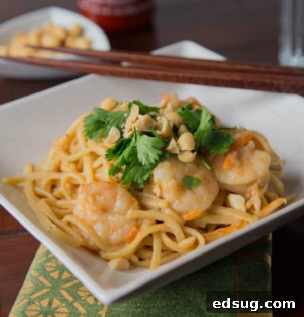Creamy One Pot Thai Shrimp Pasta topped with cilantro and peanuts.