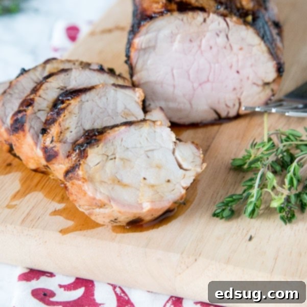 Perfectly grilled Herb Grilled Pork Tenderloin, sliced and ready to serve