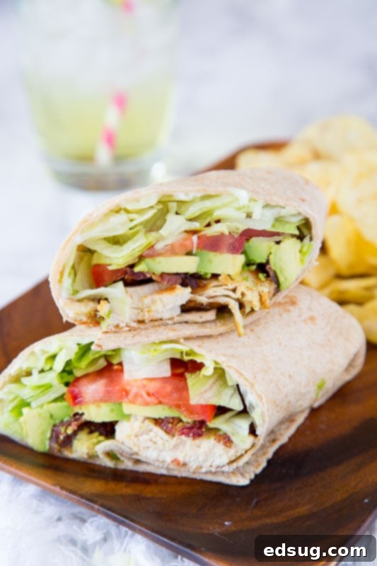 A perfectly rolled and sliced Chicken Club Wrap, highlighting the layers of ingredients within.