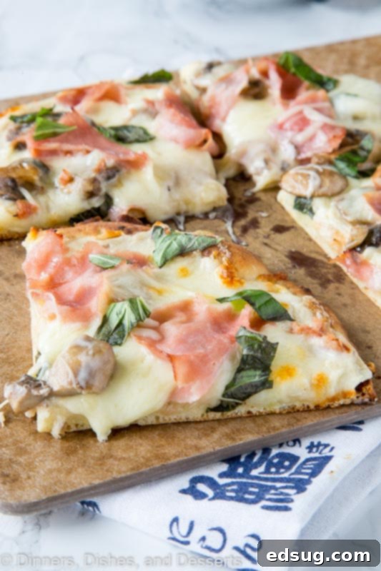 White Forest & Farm Pizza 2 A slice of pizza with mushrooms, ham, and white sauce