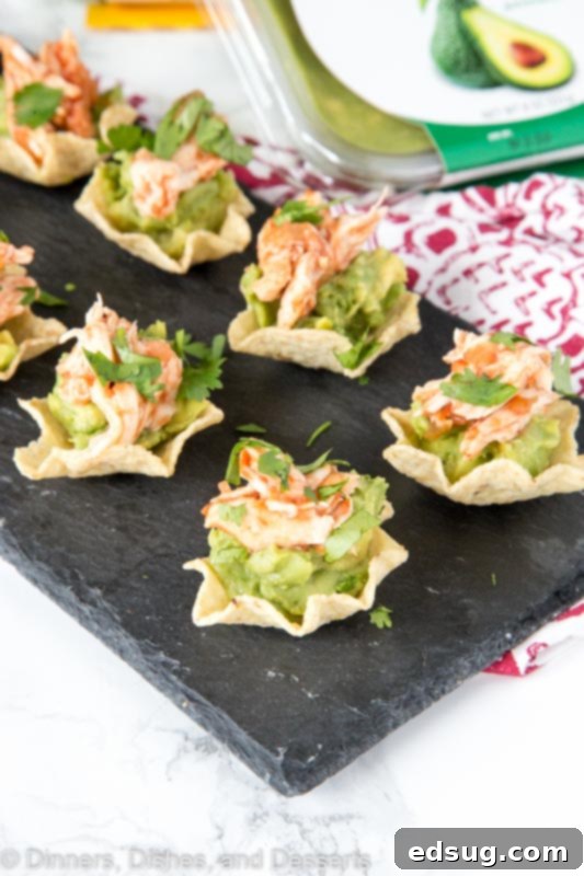 Zesty Avocado Chicken Poppers 3 Close-up of golden tortilla chip scoops generously filled with mashed avocado and savory shredded chicken.