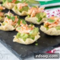 Zesty Avocado Chicken Poppers 6 Guacamole Chicken Bites - A delightful and easy chicken appetizer for any gathering, featuring creamy guacamole, spicy salsa chicken, and fresh cilantro on crunchy tortilla scoops.